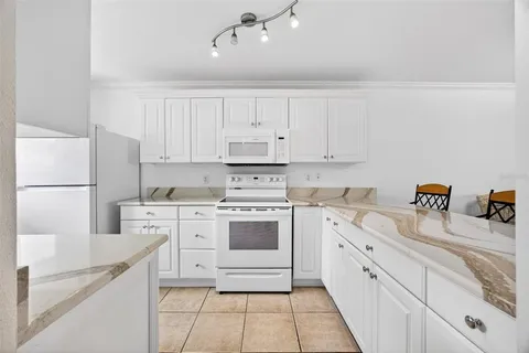a kitchen with a sink cabinets and window