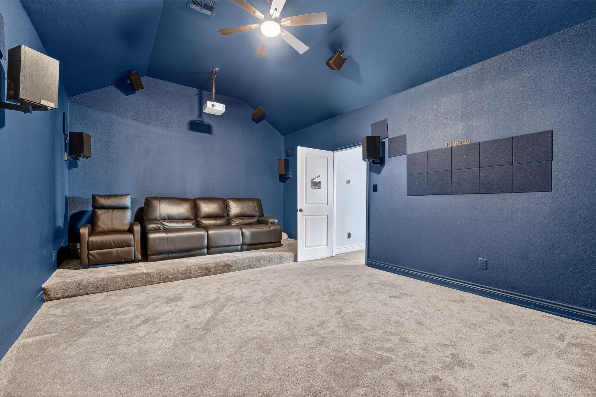 400 Cortona Lane Georgetown, TX 78628 - Photo 32 of 40 Home theater featuring carpet flooring, ceiling fan, vaulted ceiling, and a textured wall