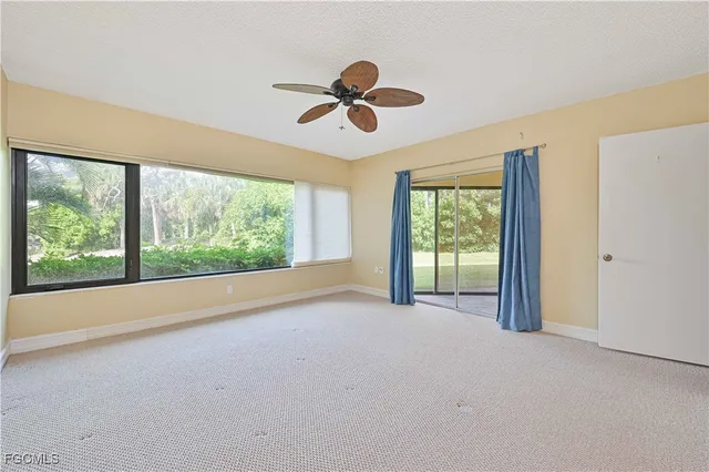 a view of a room with window ceiling fan and window