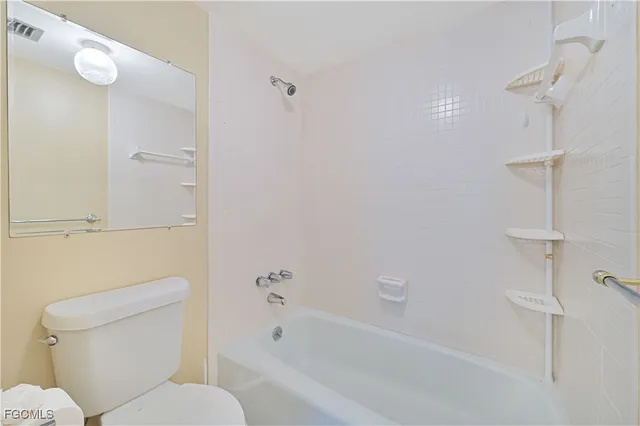 a bathroom with a toilet and shower