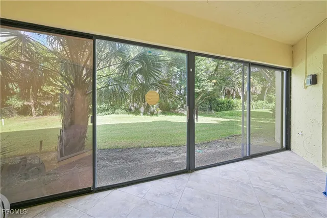 a view of backyard with large windows and swimming pool