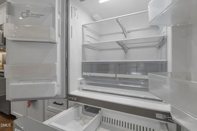 a view of walk in closet with empty racks