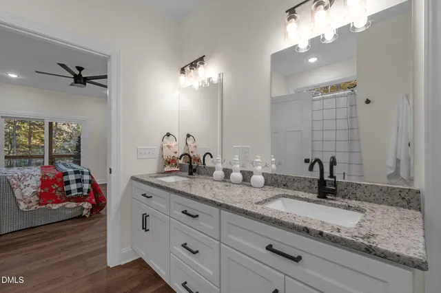 a bathroom with double vanity and a granite counter tops