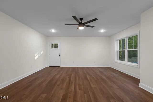 wooden floor in an empty room with a window