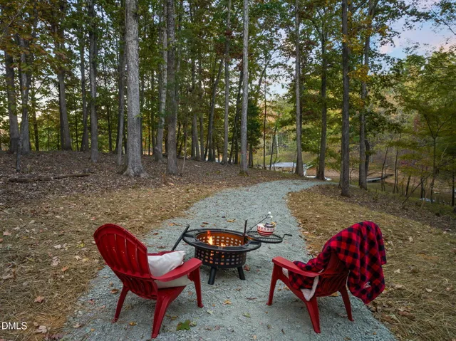 an aerial view of ocean and residential houses with outdoor space