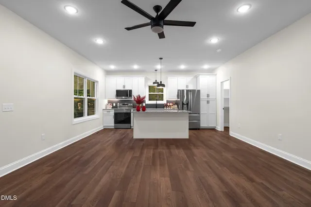 a view of kitchen with microwave and wooden floor