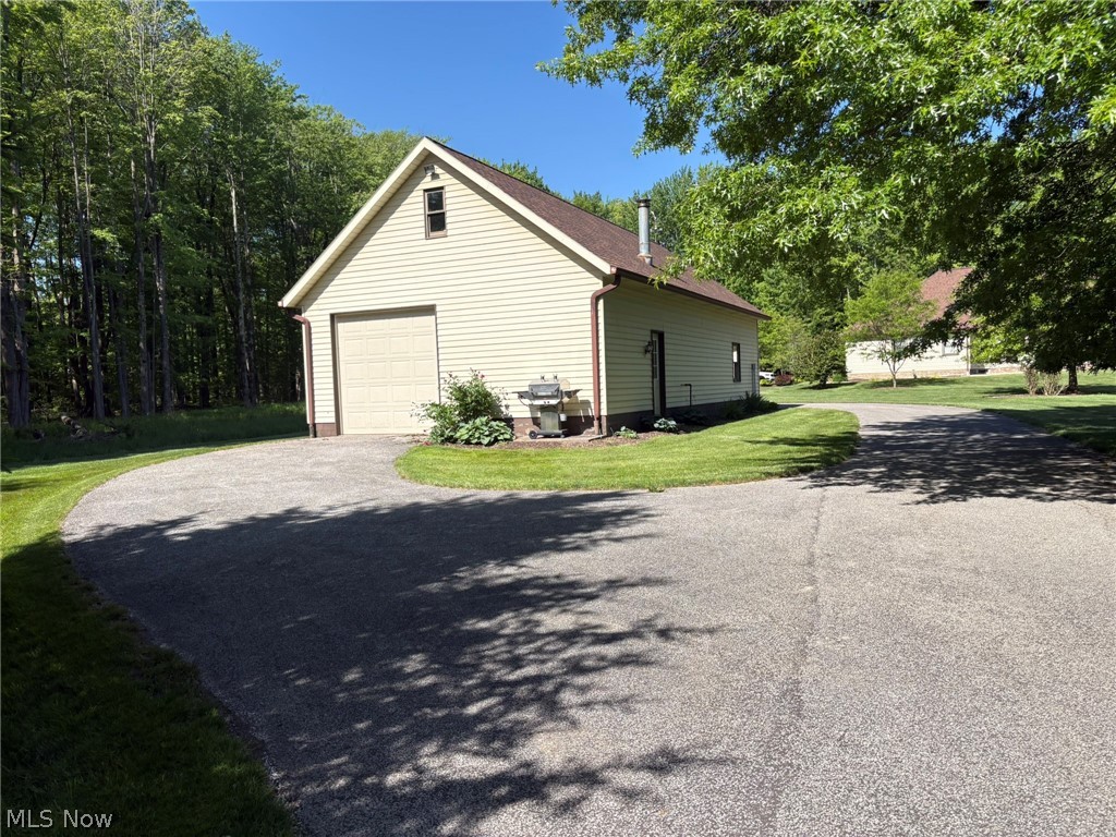6475 Taylor Road Painesville, OH 44077 - Photo 16 of 23 Out building 1 of 2 with 220 AMP, Gas furnace & Hot and cold water. 8" garage door at each end.Drive thru