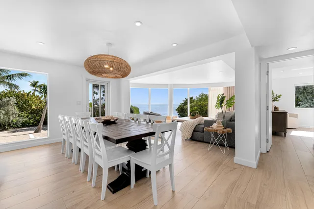 a living room with furniture a wooden floor and a large window