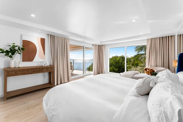 a large bedroom with a bed and a large window