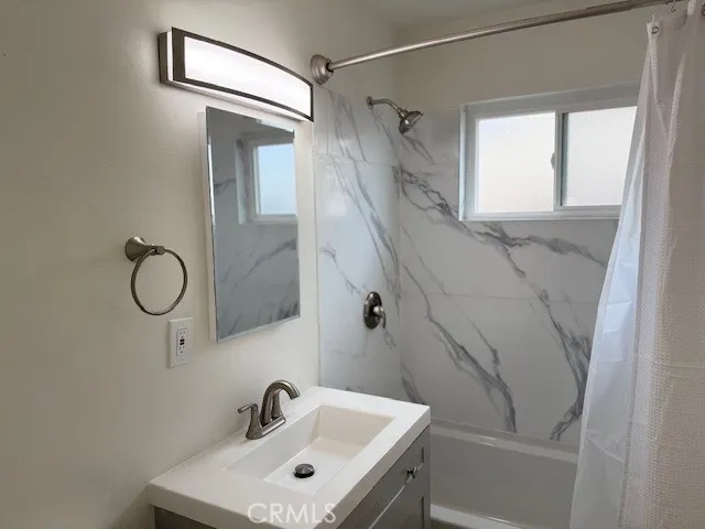 a view of wooden floor and a chandelier fan in a room