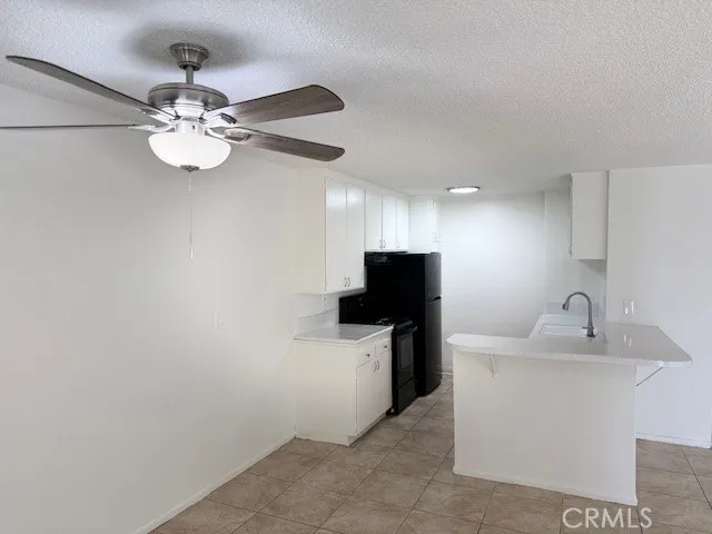 a kitchen with a sink and a refrigerator