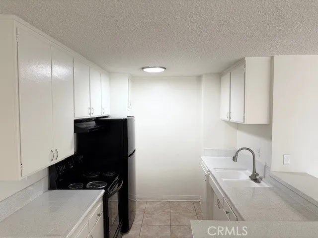 a kitchen with a sink and a stove top oven