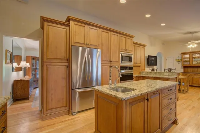 a kitchen with stainless steel appliances and cabinets