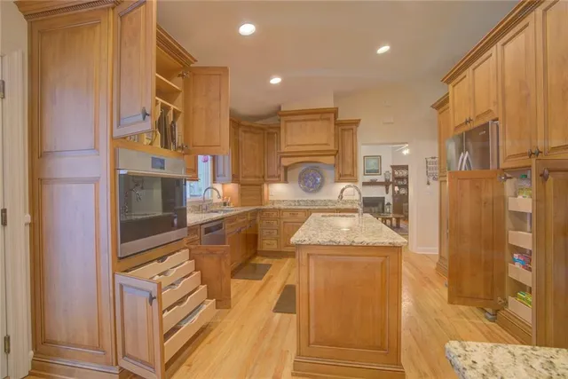 a view of a dining room with furniture a chandelier and wooden floor