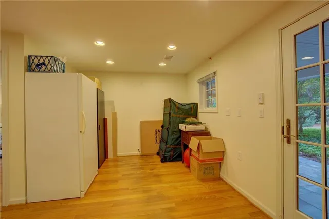 a view of a field with trees in the background