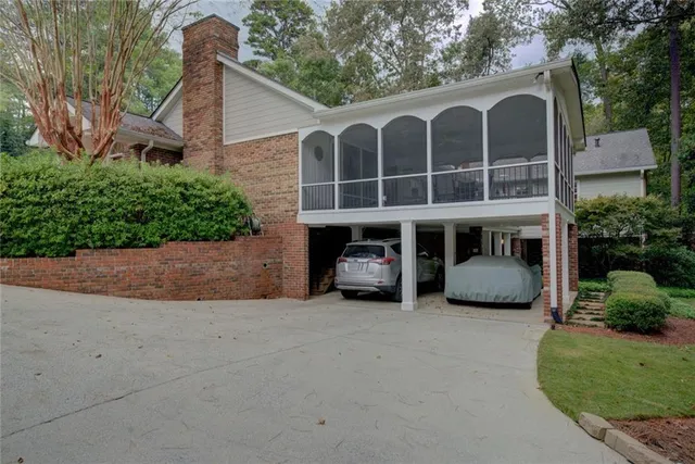 a view of a house with large windows and a small yard