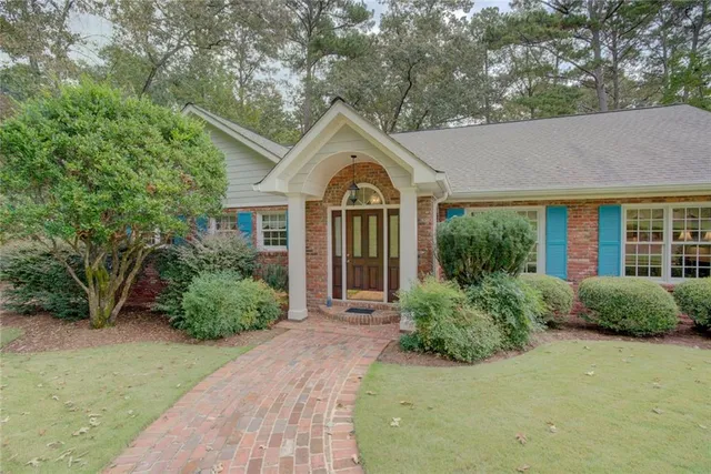 a view of a bedroom with wooden floor and furniture