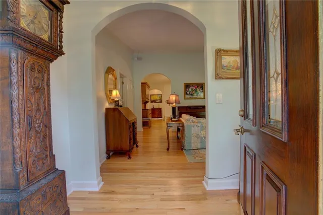 a living room with furniture and a large mirror or wooden floor
