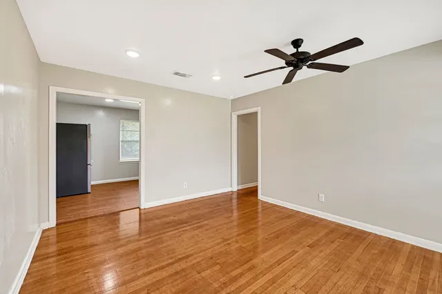 a view of a big room with wooden floor and closet area