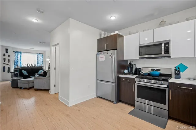 a kitchen with stainless steel appliances a refrigerator stove and microwave