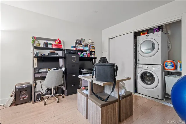 a view of a storage and utility room with washer and dryer