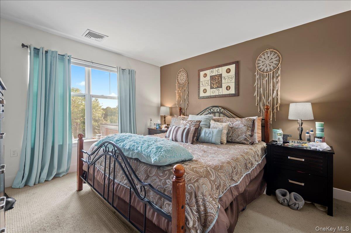 710 Main Street Peekskill, NY 10566 - Photo 15 of 26 a bedroom with a bed and a chandelier