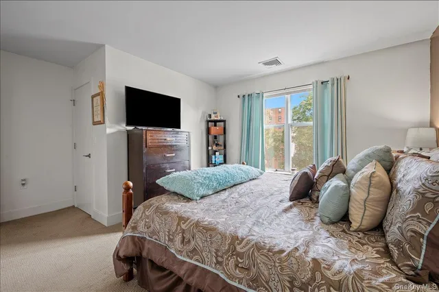 a bedroom with a bed and a television