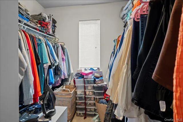 a view of walk in closet with clothes