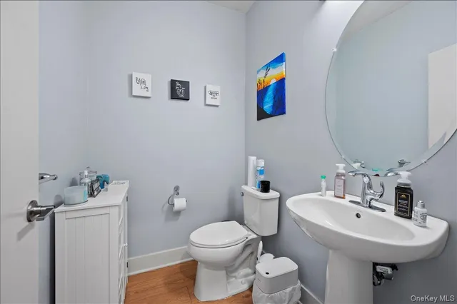 a bathroom with a toilet sink and mirror