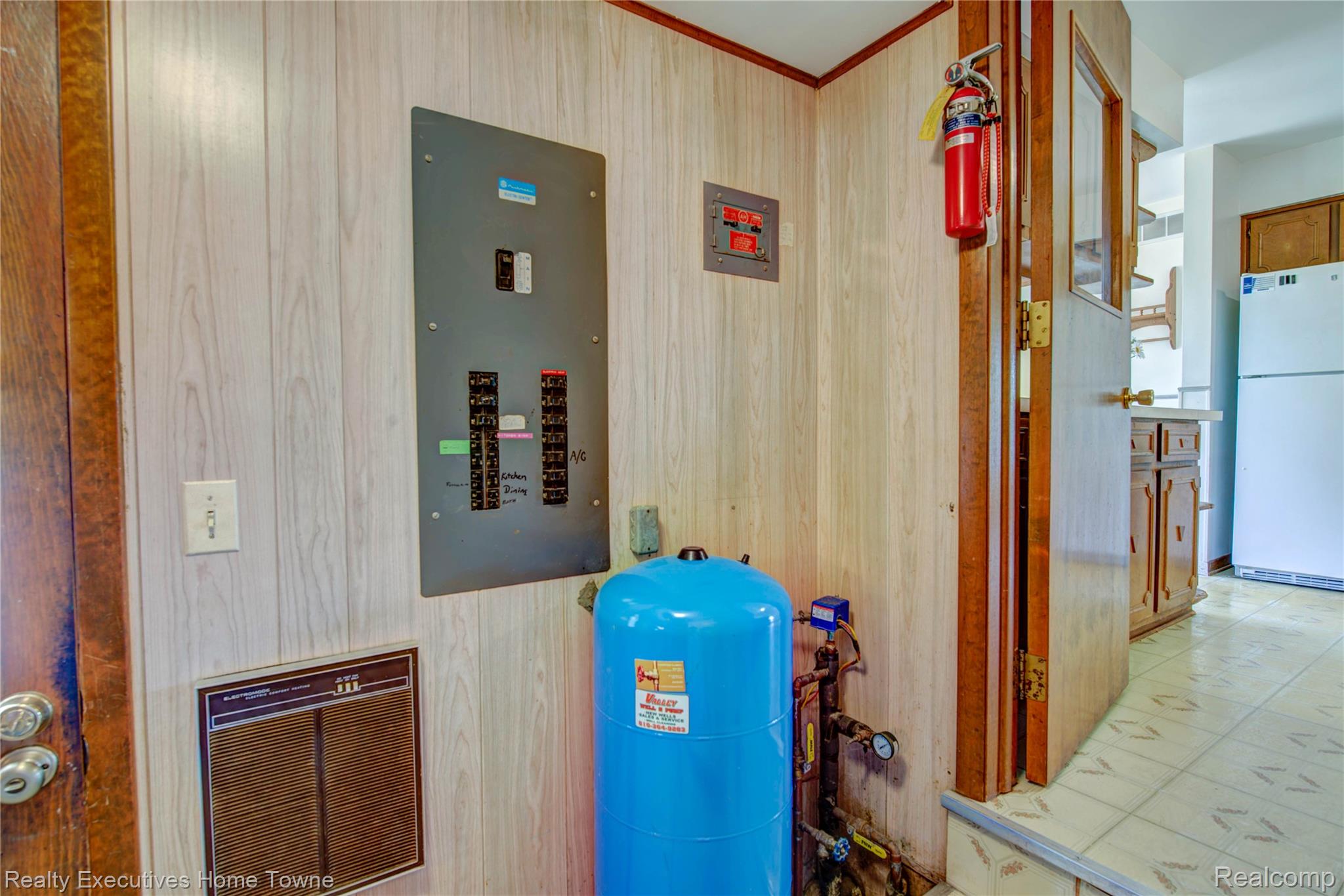 8728 Rynn Road Avoca, MI 48006 - Photo 52 of 53 Light wood-finish wall paneling featuring a main electrical panel and a blue pressure tank