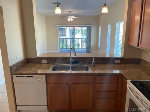 a kitchen with granite countertop a sink and a window