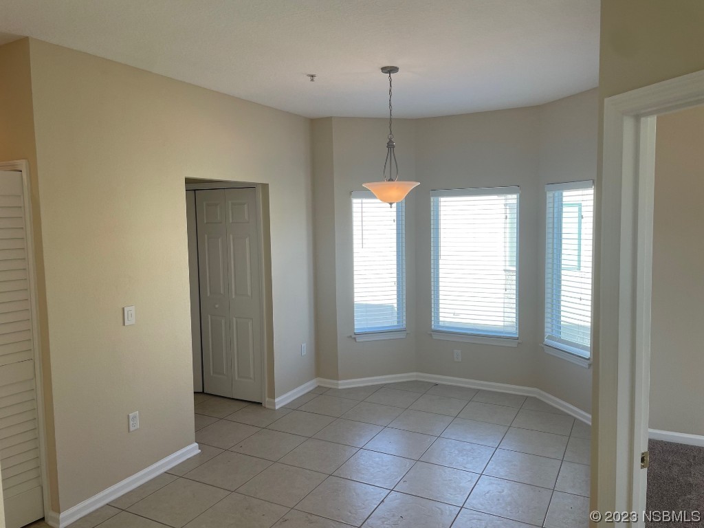 Undisclosed Address New Smyrna Beach, FL 32169 - Photo 5 of 22 an empty room with window and chandelier fan