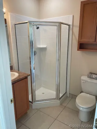 a bathroom with a shower a toilet and a sink