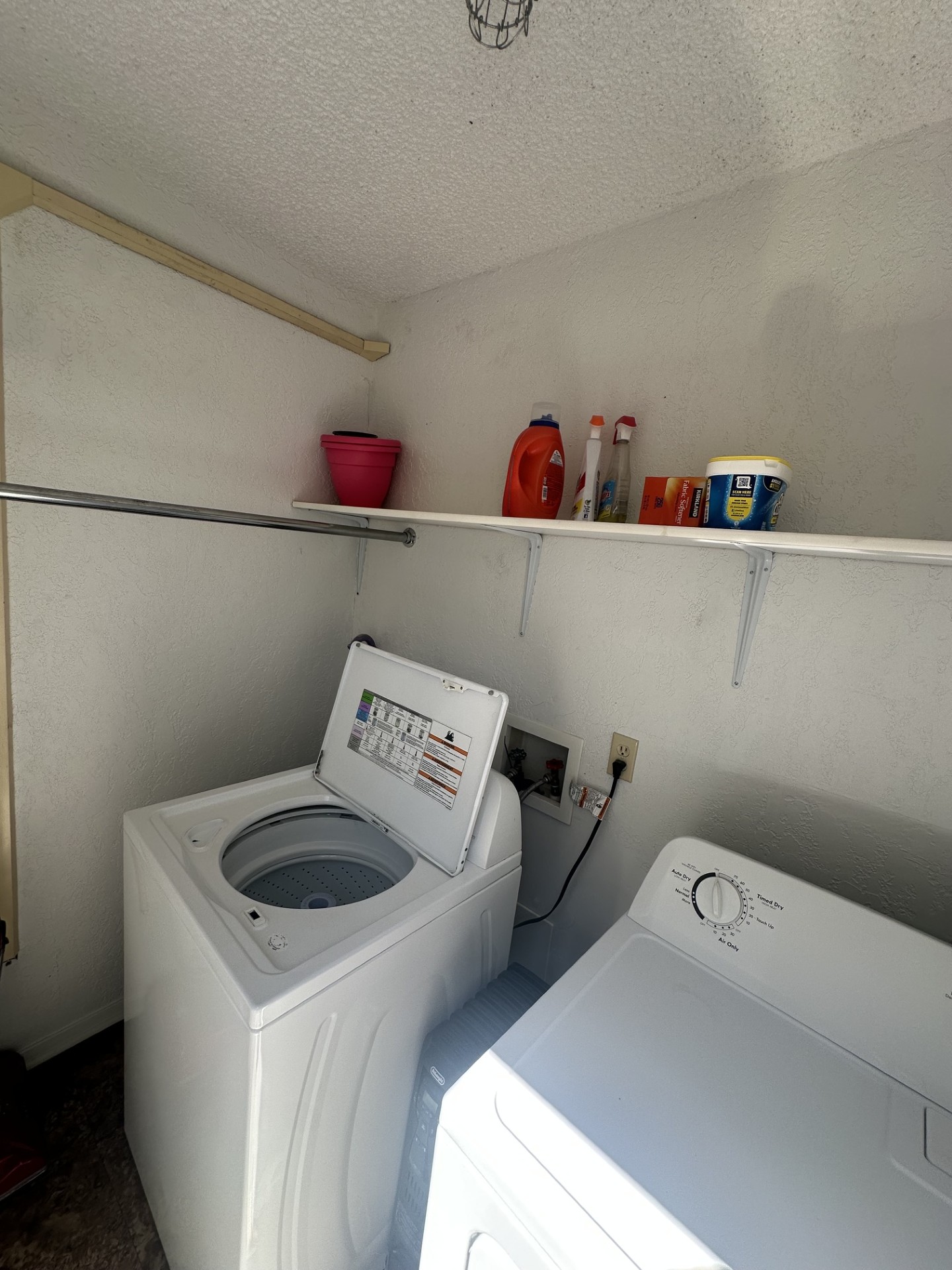 2215 Post Road, Unit 2044 Austin, TX 78704 - Photo 27 of 34 Functional laundry setup features high shelving and built-in hanging rods.