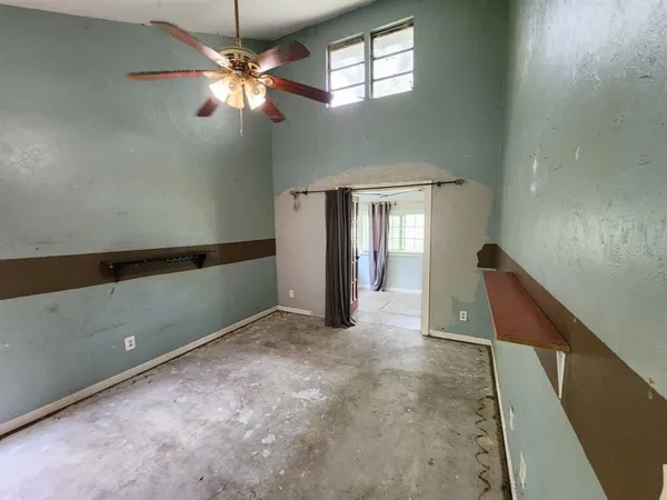 a view of a livingroom with a ceiling fan and window