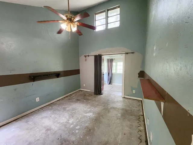 a view of a livingroom with a ceiling fan and window