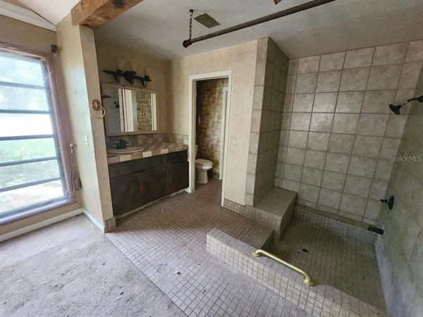 a view of an empty room with a bathroom