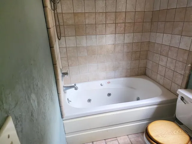 a bathroom with a bathtub and toilet