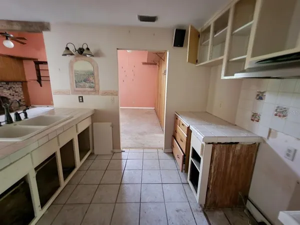 a kitchen with a sink a stove and cabinets
