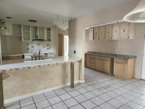 a kitchen with granite countertop a sink and a stove