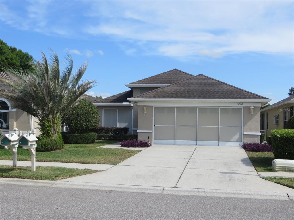 15002 Tamarind Loop Spring Hill, FL 34609 - Photo 1 of 1 a house view with a garden space