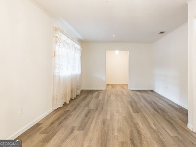 5209 Highway 32 Patterson, GA 31557 - Photo 16 of 45 an empty room with wooden floor and windows
