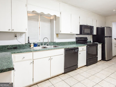 5209 Highway 32 Patterson, GA 31557 - Photo 18 of 45 a kitchen with granite countertop white cabinets and stainless steel appliances