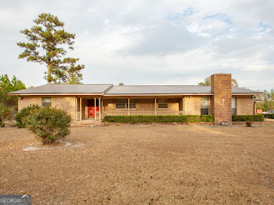 5209 Highway 32 Patterson, GA 31557 - Photo 2 of 45 a front view of a house with a yard and garage