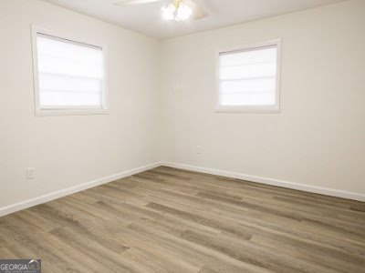 5209 Highway 32 Patterson, GA 31557 - Photo 25 of 45 an empty room with wooden floor and windows