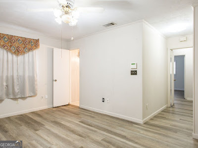 5209 Highway 32 Patterson, GA 31557 - Photo 35 of 45 a view of a livingroom with wooden floor and a ceiling fan