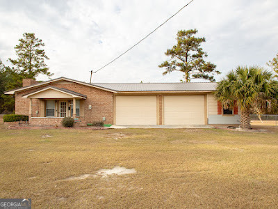 5209 Highway 32 Patterson, GA 31557 - Photo 6 of 45 a front view of a house with a yard and garage