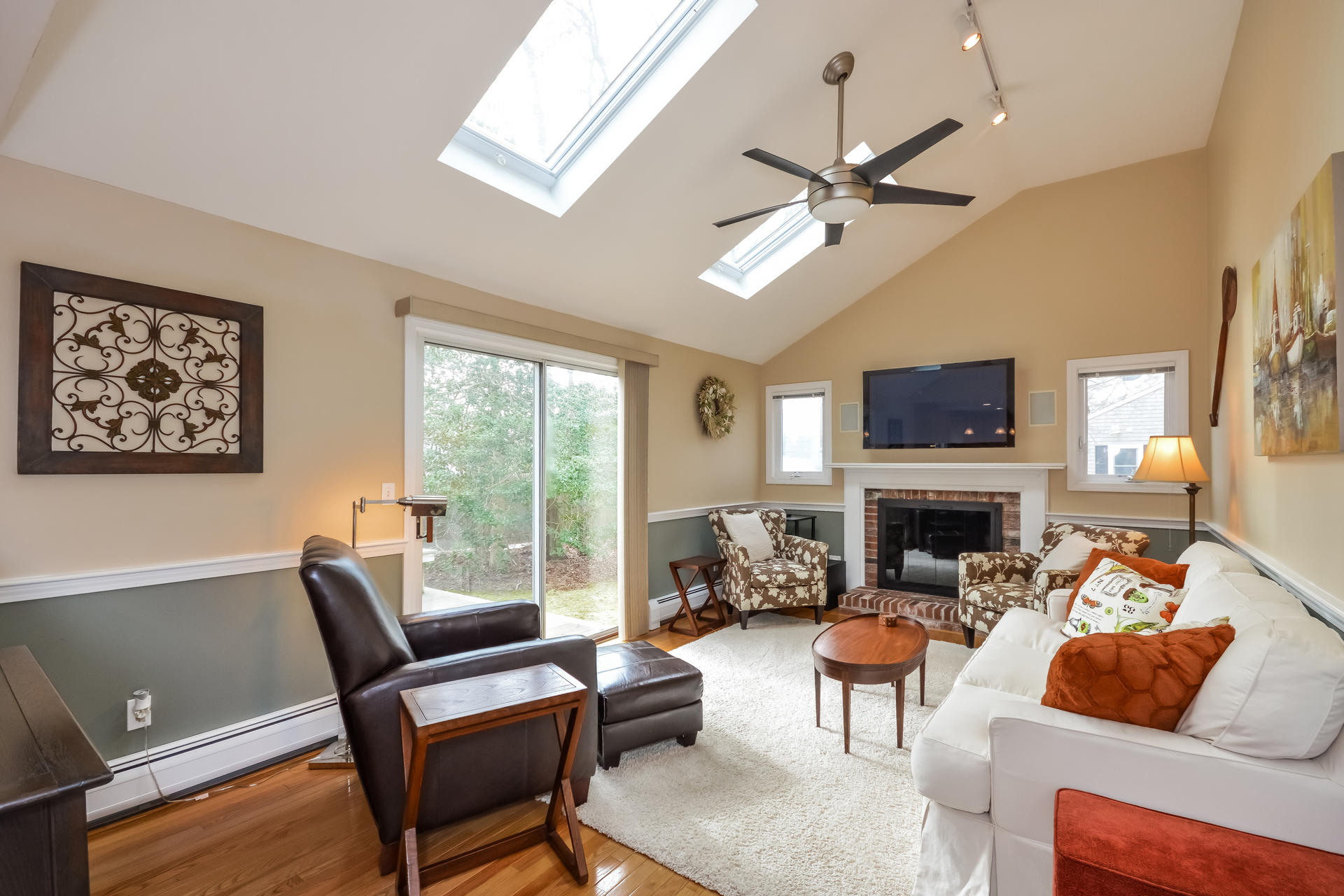 188 Ansel Howland Road Centerville, MA 02632 - Photo 1 of 24 a living room with furniture a fireplace and a large window