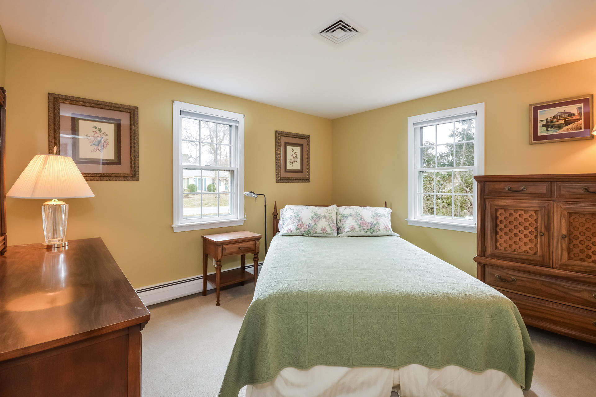 188 Ansel Howland Road Centerville, MA 02632 - Photo 15 of 24 a bedroom with a bed a table and chair
