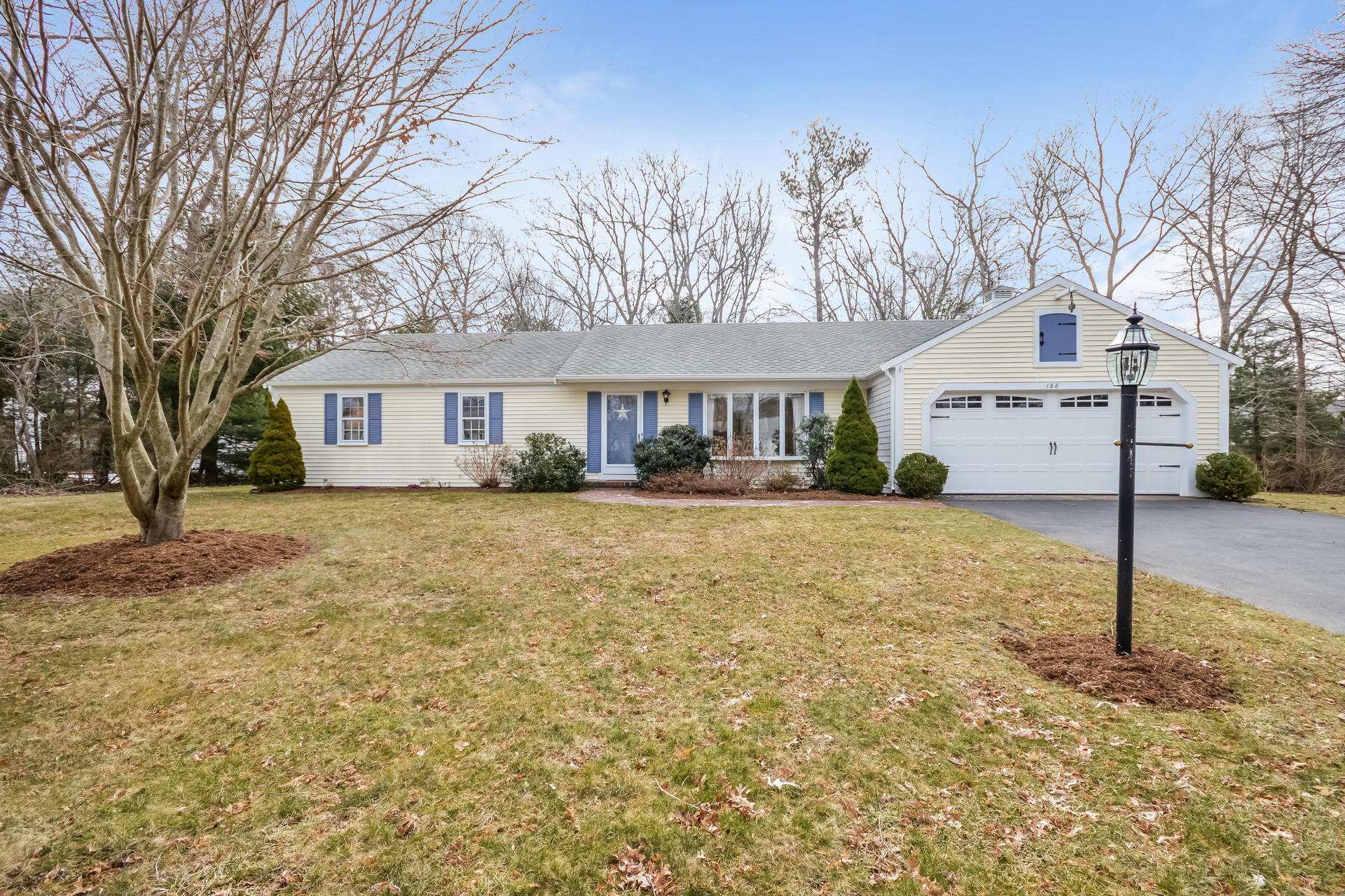 188 Ansel Howland Road Centerville, MA 02632 - Photo 2 of 24 a front view of a house with a yard and garage